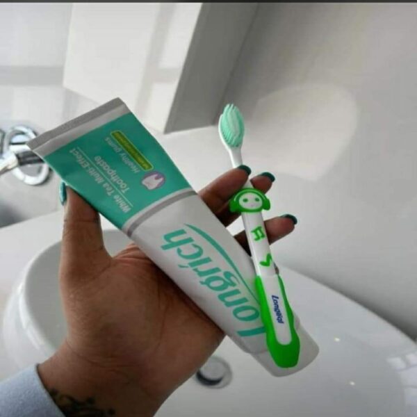 a man holding longrich non floruide white tea toothpaste with longrich toothbrush